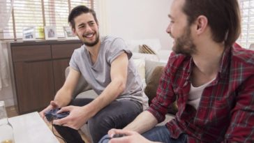 Two guy playing PlayStation