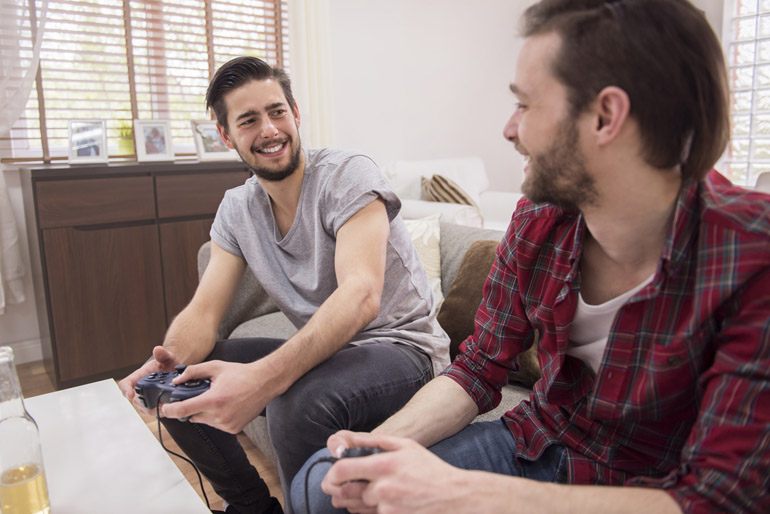 Two guy playing PlayStation