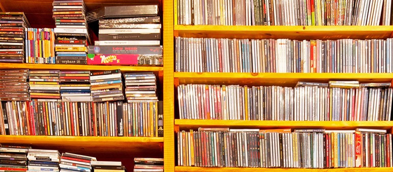 Shelf with a ton of CDs and books