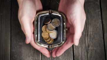 Hands holding money purse