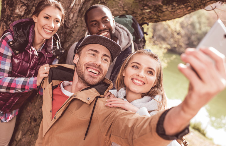 a group of young people taking selfie