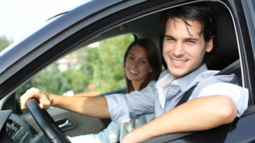 Cheerful couple driving car