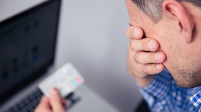 Upset man holding credit card