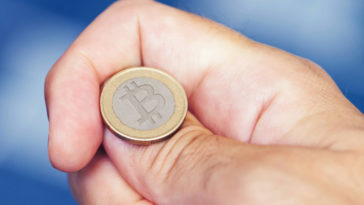hand tossing bitcoin